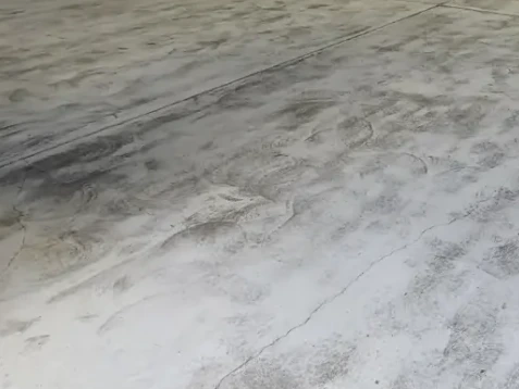 Worn distribution center concrete floor before epoxy coating